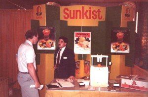 A man standing in front of a table with food on it.