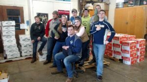 Group of young men posing together in a casual indoor setting.